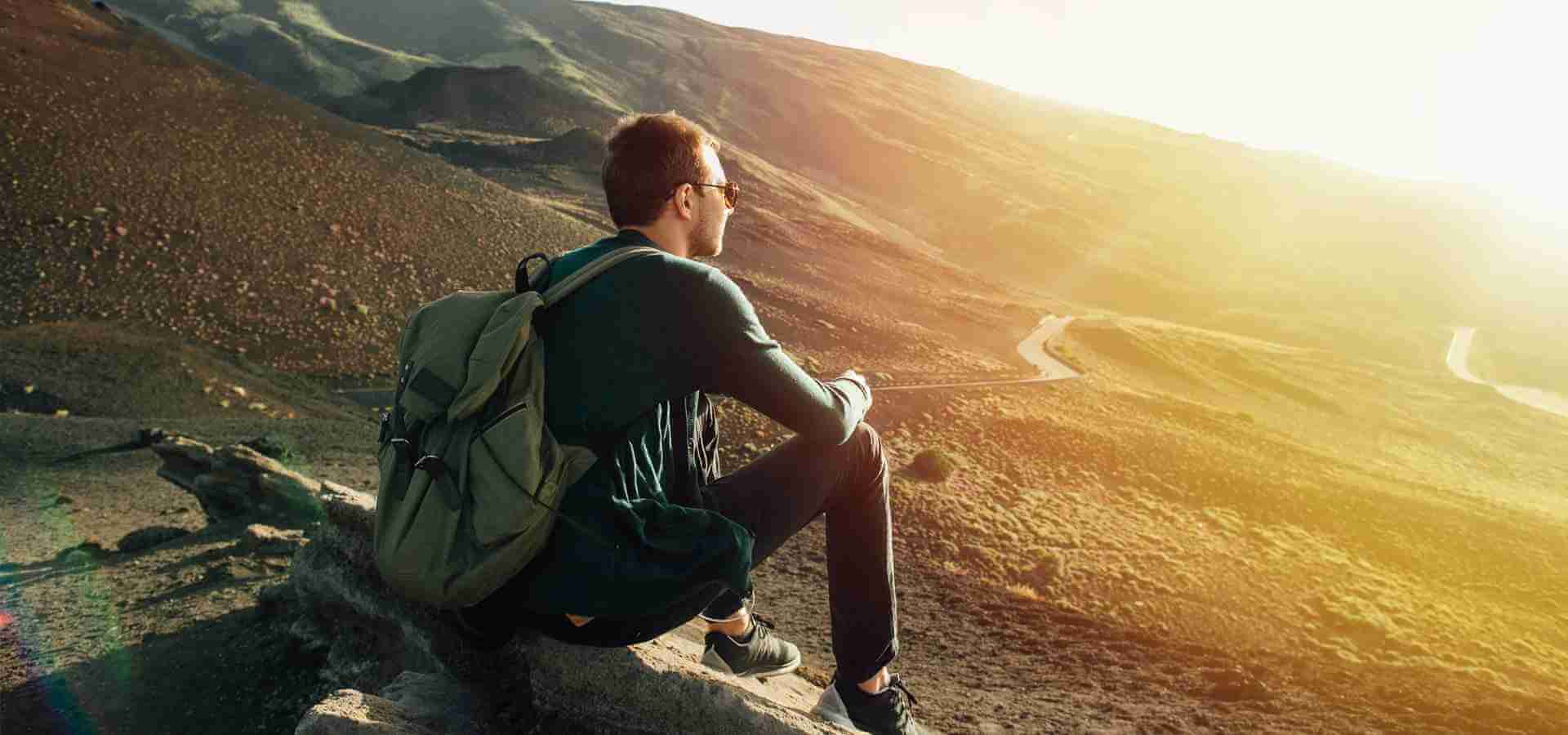 The traveller, sitting alone, gazes